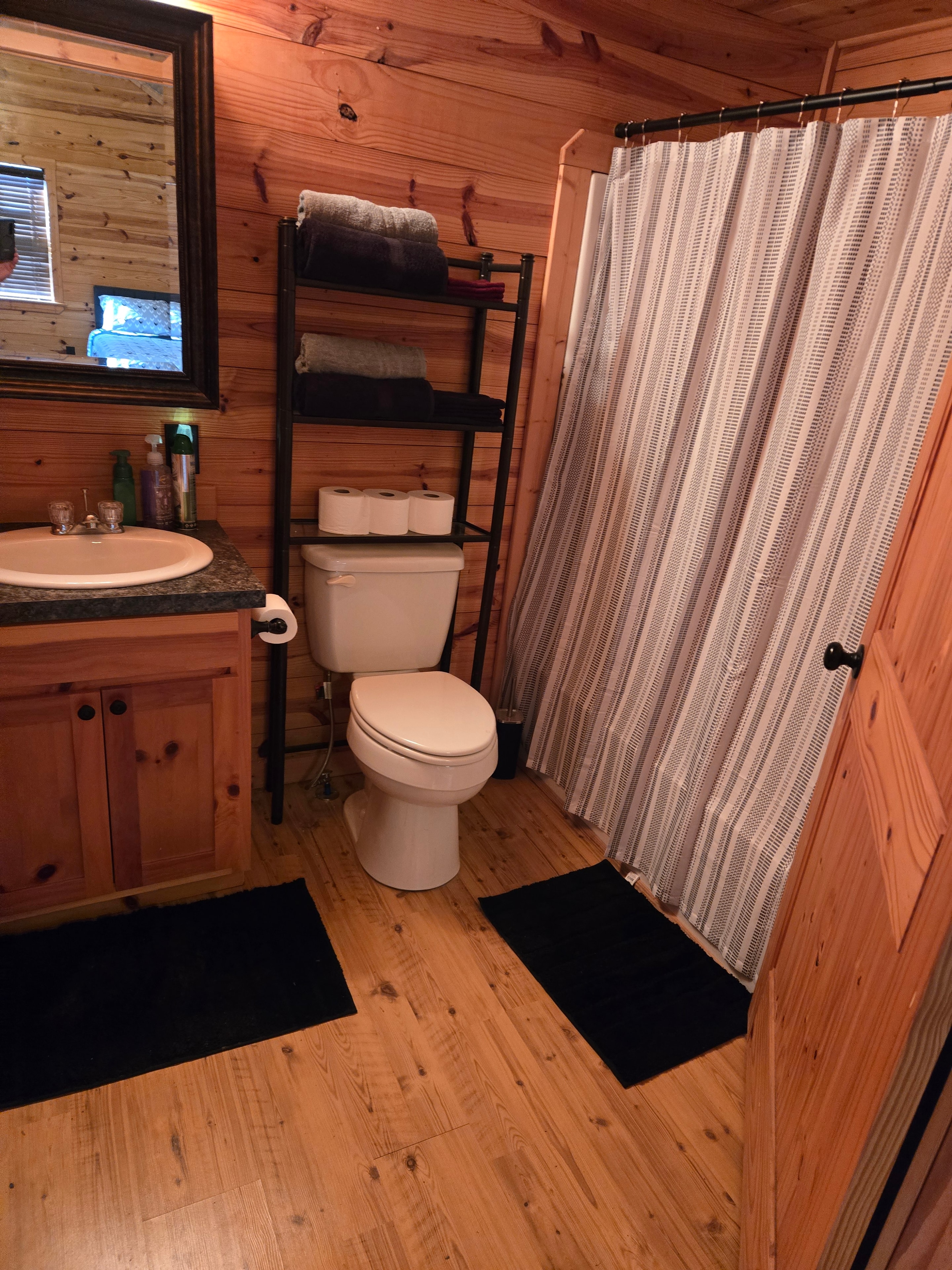 Exterior of the ranch cabin — rustic wood siding with metal roof, Karnes County Texas