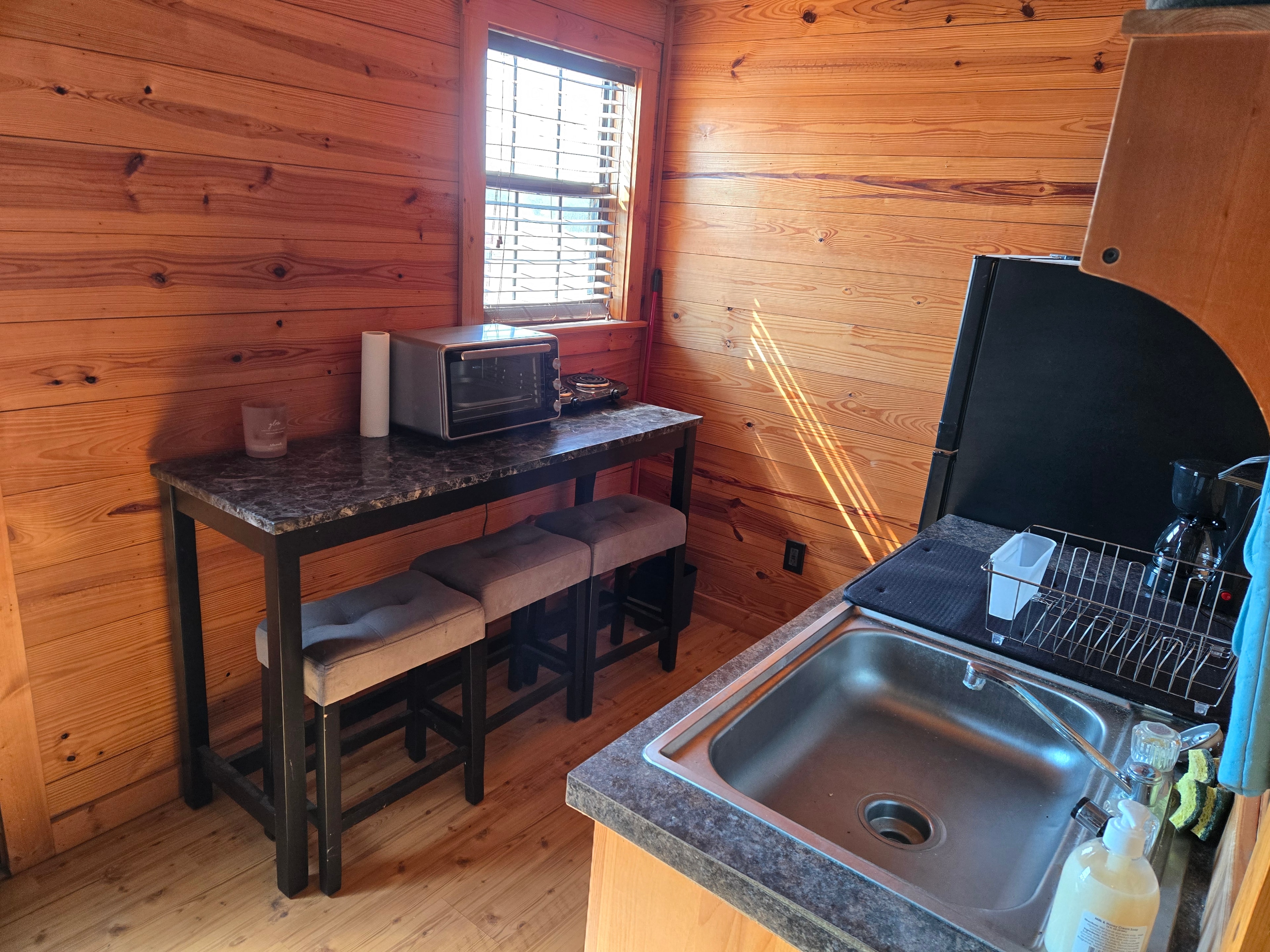 Cabin kitchenette with sink, toaster oven, and mini fridge